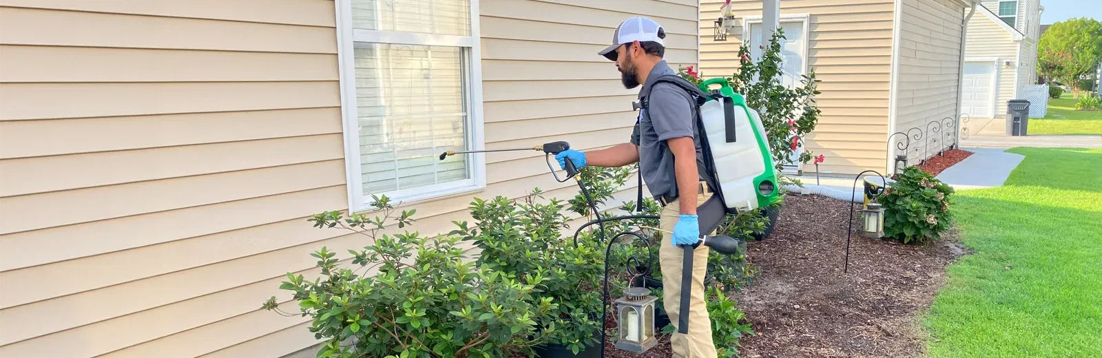 pest control spraying exterior of home